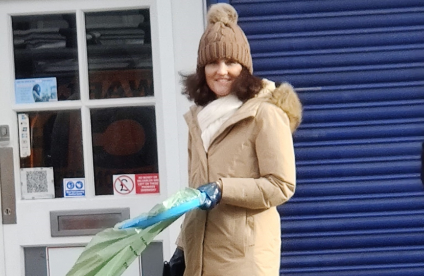 Theresa Villiers taking part in a volunteer litter-pick